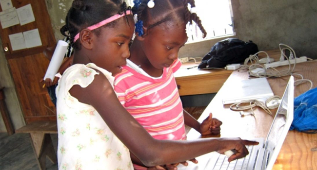 Haitian students viewing content on laptop screen